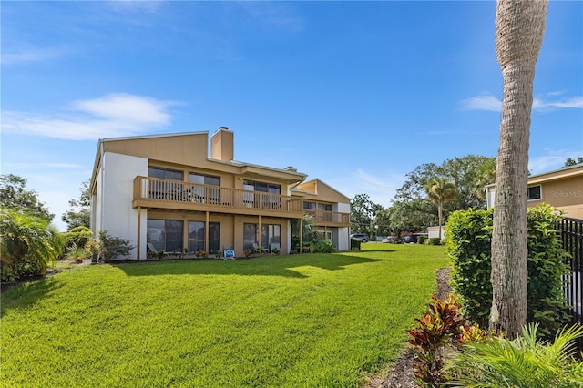 1051 S Highland St Unit 7D, Mount Dora, FL 32757 - rear view of property with a balcony, a yard, stucco siding, and a chimney