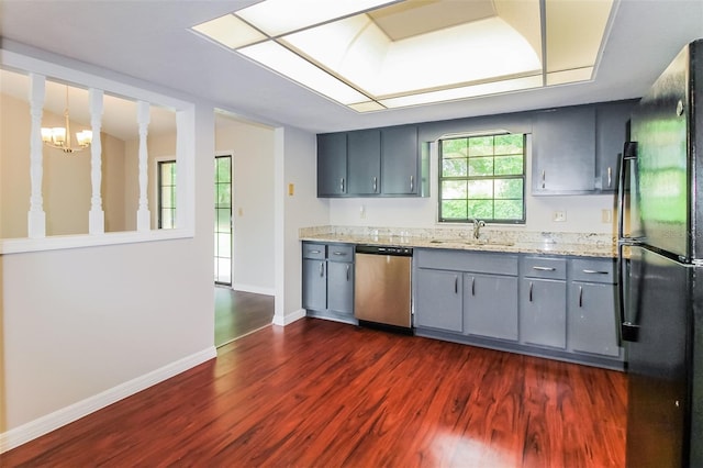 10448 SW 74th Ct, Ocala, FL 34476 - kitchen featuring dishwasher, freestanding refrigerator, gray cabinetry, dark wood-type flooring, and light stone countertops