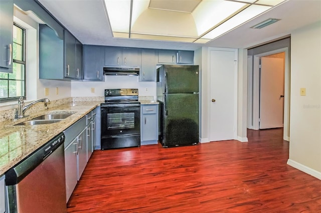 10448 SW 74th Ct, Ocala, FL 34476 - kitchen featuring black appliances, under cabinet range hood, dark wood-type flooring, light stone countertops, and gray cabinetry