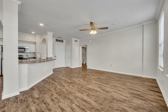 911 N Orange Ave Unit 443, Orlando, FL 32801 - unfurnished living room with a ceiling fan, ornamental molding, wood finished floors, and recessed lighting