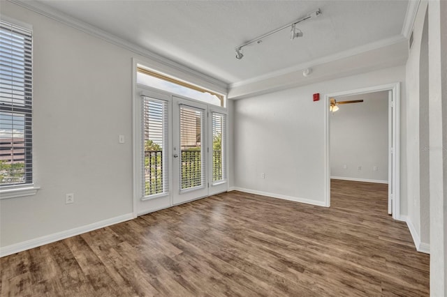 911 N Orange Ave Unit 443, Orlando, FL 32801 - spare room featuring rail lighting, healthy amount of natural light, wood finished floors, and crown molding