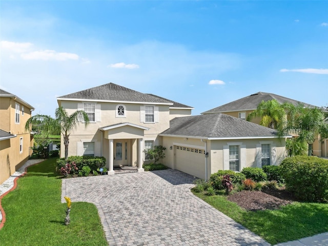5819 Covington Cove Way, Orlando, FL 32829 - view of front of property with a garage, stucco siding, decorative driveway, and a front yard