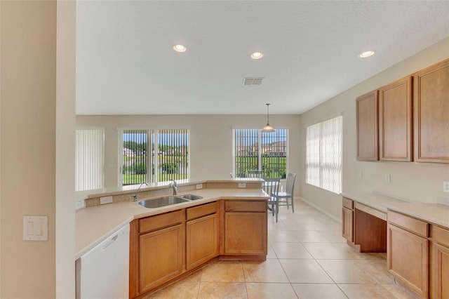 5819 Covington Cove Way, Orlando, FL 32829 - kitchen with white dishwasher, light countertops, light tile patterned floors, recessed lighting, and pendant lighting