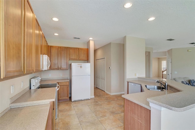 5819 Covington Cove Way, Orlando, FL 32829 - kitchen featuring white appliances, light countertops, a textured ceiling, recessed lighting, and a peninsula