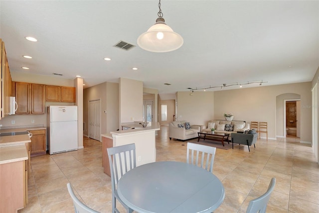 5819 Covington Cove Way, Orlando, FL 32829 - dining room with light tile patterned floors, arched walkways, and recessed lighting