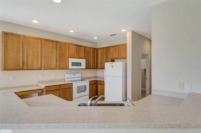 5819 Covington Cove Way, Orlando, FL 32829 - kitchen featuring white appliances, recessed lighting, light countertops, brown cabinetry, and a peninsula