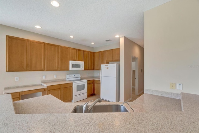 5819 Covington Cove Way, Orlando, FL 32829 - kitchen with white appliances, recessed lighting, light countertops, a textured ceiling, and brown cabinets