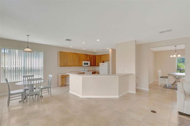 5819 Covington Cove Way, Orlando, FL 32829 - kitchen with white appliances, light countertops, light tile patterned flooring, a chandelier, and recessed lighting
