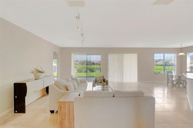 5819 Covington Cove Way, Orlando, FL 32829 - living room featuring light tile patterned floors and arched walkways
