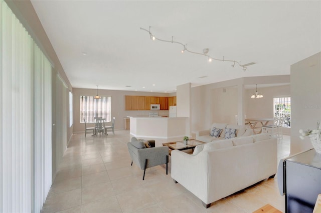 5819 Covington Cove Way, Orlando, FL 32829 - living area featuring a chandelier and light tile patterned floors