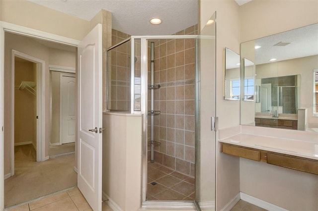 5819 Covington Cove Way, Orlando, FL 32829 - full bathroom with a stall shower, a spacious closet, vanity, tile patterned floors, and recessed lighting