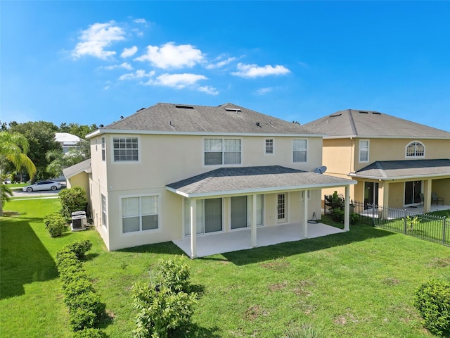 5819 Covington Cove Way, Orlando, FL 32829 - back of property featuring a patio area, stucco siding, and roof with shingles