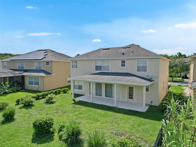 5819 Covington Cove Way, Orlando, FL 32829 - rear view of house with a patio, a yard, stucco siding, and roof with shingles