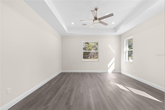 12258 SW 76th Ln, Dunnellon, FL 34432 - empty room with a tray ceiling, dark wood-type flooring, ceiling fan, and recessed lighting