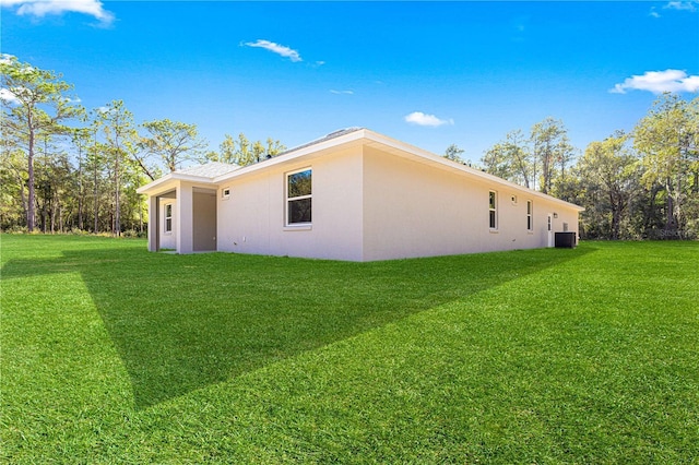 12258 SW 76th Ln, Dunnellon, FL 34432 - view of side of home with a lawn and stucco siding