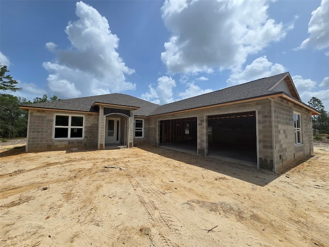 12258 SW 76th Ln, Dunnellon, FL 34432 - view of front facade with concrete block siding, a garage, a shingled roof, and driveway