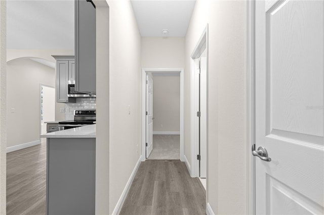 12258 SW 76th Ln, Dunnellon, FL 34432 - corridor featuring light wood-style floors and arched walkways