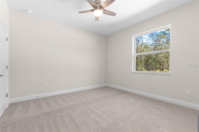 12258 SW 76th Ln, Dunnellon, FL 34432 - empty room featuring light carpet, ceiling fan, and a smoke detector