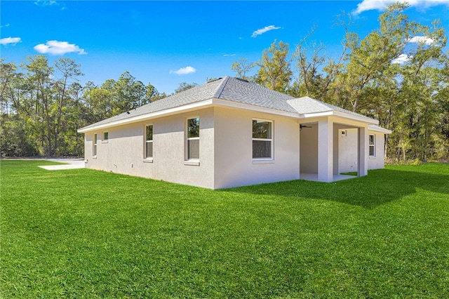 12258 SW 76th Ln, Dunnellon, FL 34432 - view of home's exterior with a lawn, stucco siding, and roof with shingles
