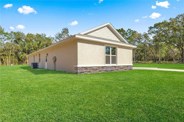 12258 SW 76th Ln, Dunnellon, FL 34432 - view of side of property featuring stucco siding, a lawn, and stone siding