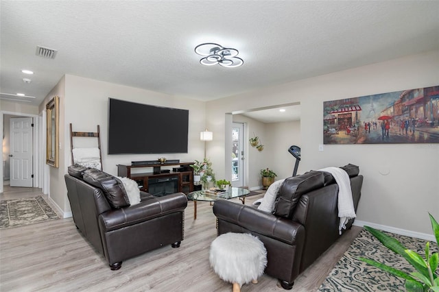 808 Camphor Way, Melbourne, FL 32901 - living room with light wood-style floors and a textured ceiling