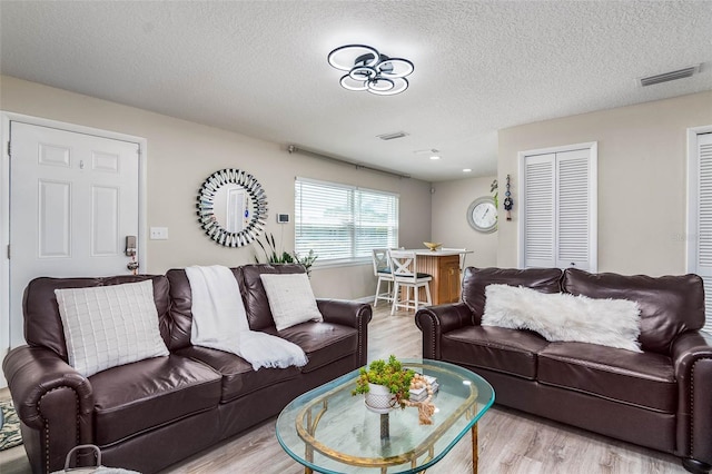 808 Camphor Way, Melbourne, FL 32901 - living area featuring light wood-style flooring and a textured ceiling