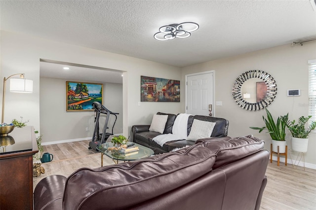 808 Camphor Way, Melbourne, FL 32901 - living area featuring light wood finished floors and a textured ceiling