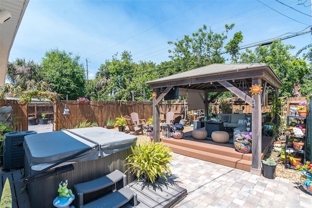 808 Camphor Way, Melbourne, FL 32901 - fenced backyard featuring a hot tub, a gazebo, a patio, an outdoor fire pit, and a wooden deck
