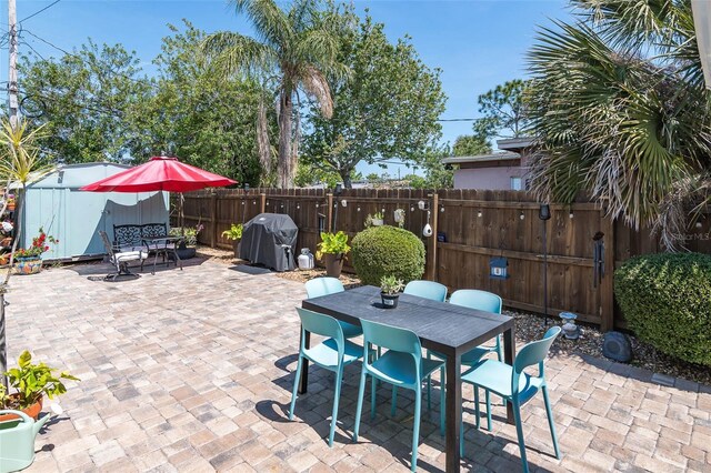 808 Camphor Way, Melbourne, FL 32901 - view of patio with outdoor dining space, grilling area, and a storage shed