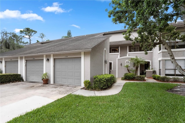 308 N Shadowbay Blvd Unit 214, Longwood, FL 32779 - townhome / multi-family property with stucco siding, a front lawn, and roof with shingles
