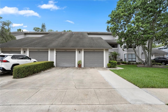 308 N Shadowbay Blvd Unit 214, Longwood, FL 32779 - view of front of home with stucco siding, driveway, a front lawn, and an attached garage