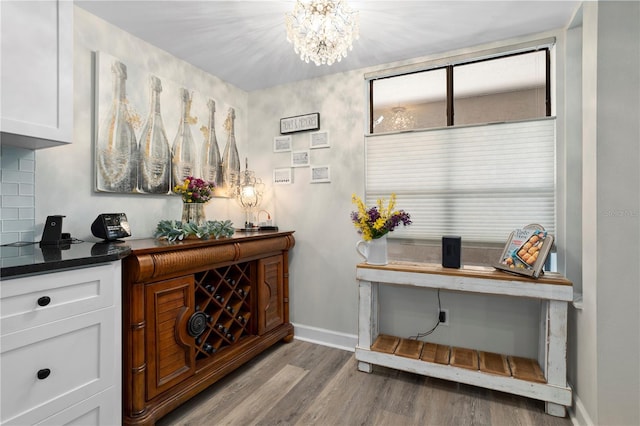 308 N Shadowbay Blvd Unit 214, Longwood, FL 32779 - bar area with wood finished floors and a chandelier