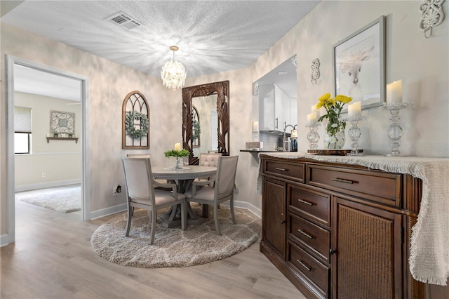 308 N Shadowbay Blvd Unit 214, Longwood, FL 32779 - dining room featuring a chandelier and light wood-type flooring