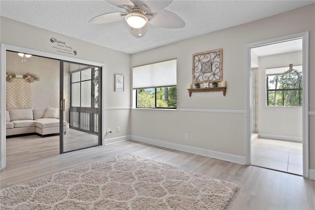 308 N Shadowbay Blvd Unit 214, Longwood, FL 32779 - unfurnished room featuring wood finished floors, a textured ceiling, and ceiling fan