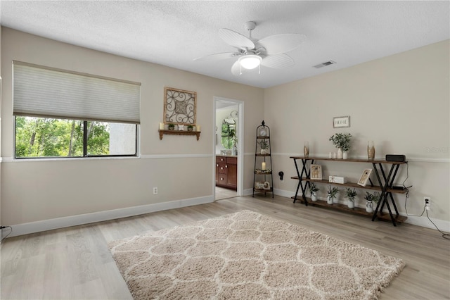 308 N Shadowbay Blvd Unit 214, Longwood, FL 32779 - living area with a ceiling fan, a textured ceiling, and wood finished floors