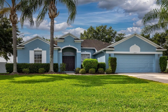 2237 Wintermere Pointe Dr, Winter Garden, FL 34787 - view of front of house featuring stucco siding, an attached garage, a front lawn, and driveway