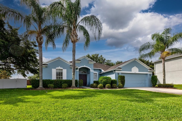 2237 Wintermere Pointe Dr, Winter Garden, FL 34787 - view of front of house featuring stucco siding, an attached garage, driveway, and a gate