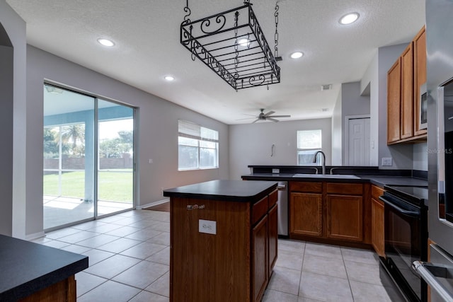 2237 Wintermere Pointe Dr, Winter Garden, FL 34787 - kitchen featuring electric range, dark countertops, a textured ceiling, recessed lighting, and a peninsula