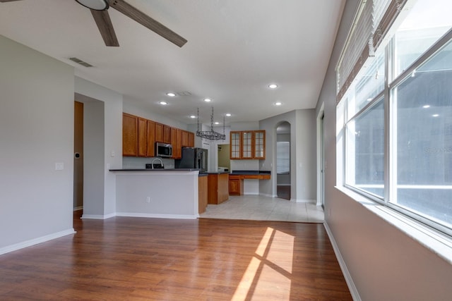 2237 Wintermere Pointe Dr, Winter Garden, FL 34787 - unfurnished living room featuring a ceiling fan, light wood-style flooring, recessed lighting, and arched walkways