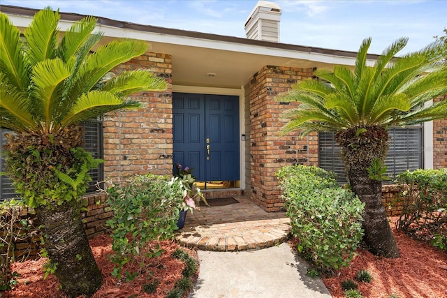 548 Timber Ridge Dr, Longwood, FL 32779 - doorway to property featuring brick siding and a chimney