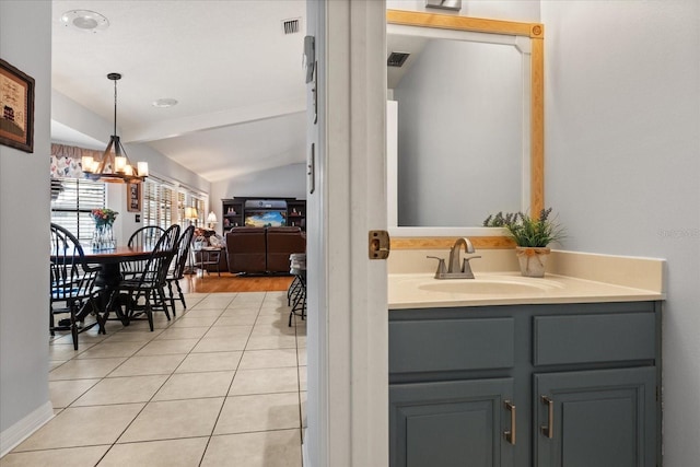 548 Timber Ridge Dr, Longwood, FL 32779 - bathroom with a chandelier, vanity, vaulted ceiling, and tile patterned flooring