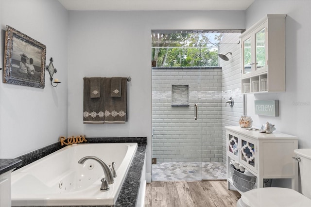 548 Timber Ridge Dr, Longwood, FL 32779 - bathroom featuring a shower stall, a jetted tub, and wood finished floors