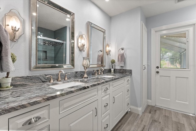 548 Timber Ridge Dr, Longwood, FL 32779 - bathroom with double vanity, wood finished floors, and tiled shower