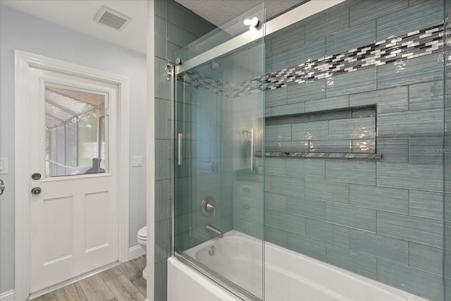 548 Timber Ridge Dr, Longwood, FL 32779 - bathroom featuring enclosed tub / shower combo and wood finished floors