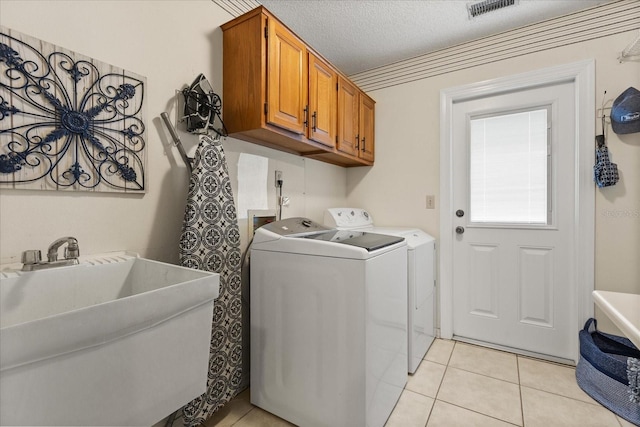 548 Timber Ridge Dr, Longwood, FL 32779 - washroom featuring light tile patterned flooring, washer and clothes dryer, and cabinet space