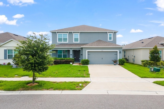 2355 White Lilly Dr, Kissimmee, FL 34747 - traditional home featuring stucco siding, a front lawn, driveway, and a garage