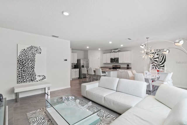 2355 White Lilly Dr, Kissimmee, FL 34747 - tiled living room featuring recessed lighting and a chandelier