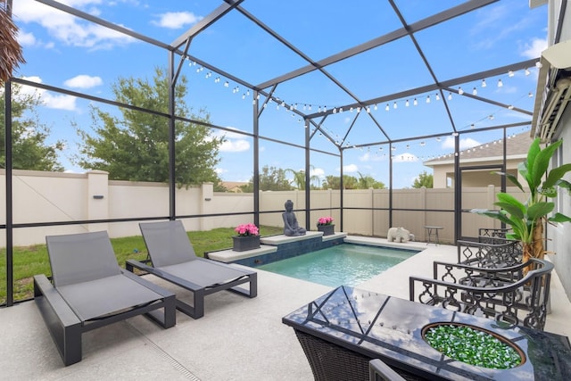 2355 White Lilly Dr, Kissimmee, FL 34747 - view of swimming pool with a patio, a fenced backyard, and glass enclosure