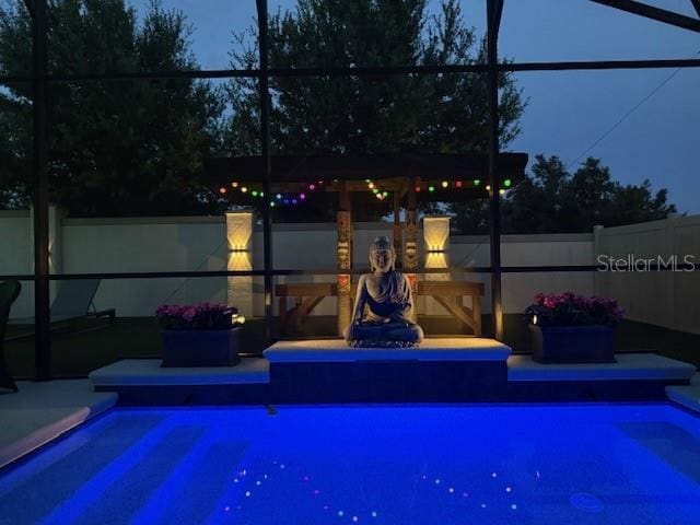 2355 White Lilly Dr, Kissimmee, FL 34747 - pool at twilight featuring a lanai