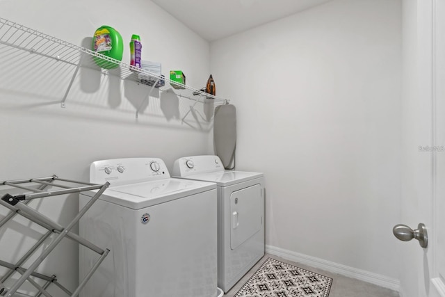2355 White Lilly Dr, Kissimmee, FL 34747 - laundry room featuring washer and clothes dryer and baseboards